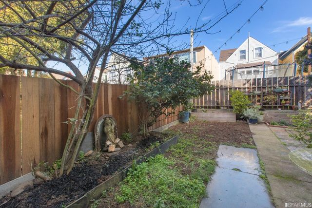 a view of a pathway with a garden