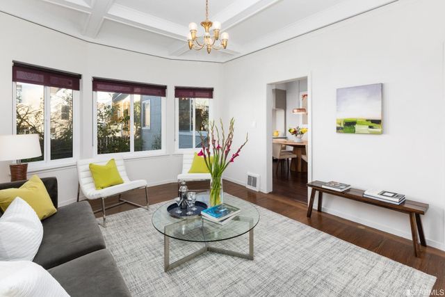 a living room with furniture a piano and a table