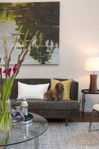 a living room with furniture and flowers