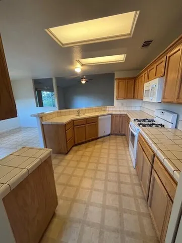 a kitchen with stainless steel appliances a cabinets and a stove top oven