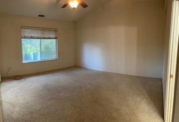 an empty room with windows and closet