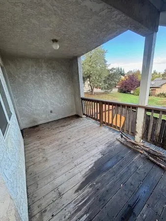 a view of balcony with wooden floor