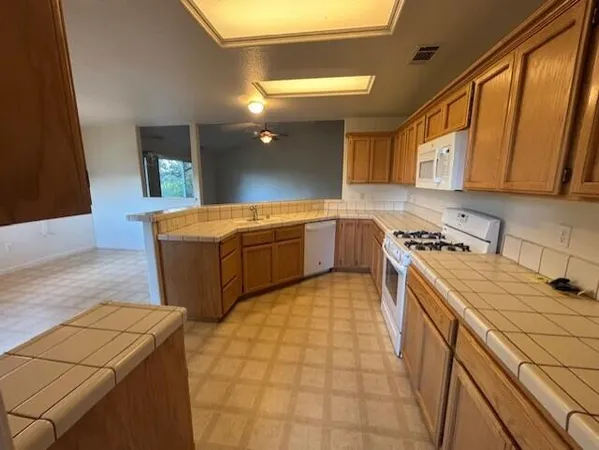 a kitchen with stainless steel appliances granite countertop a sink and a stove