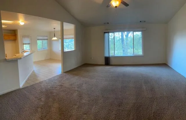 an empty room with yard and windows