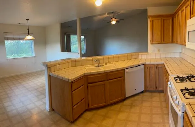 a utility room with sink dryer and washer