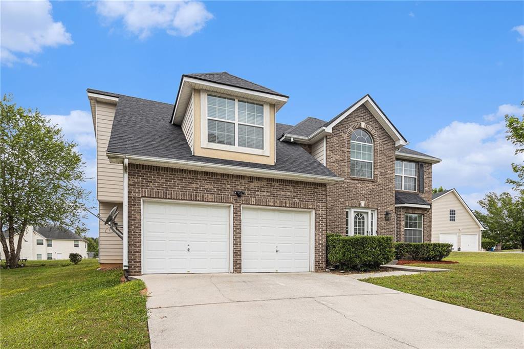a front view of a house with a yard