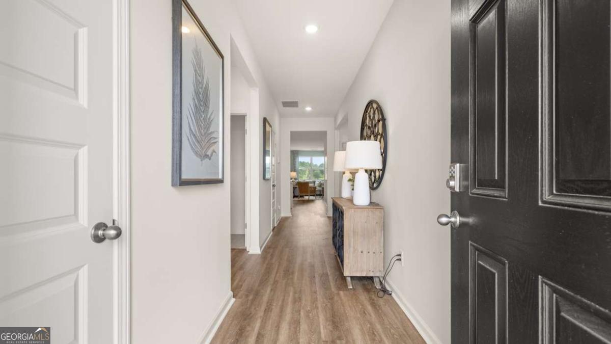 204 Cattle Drive Perry, GA 31069 - Photo 22 of 44 a view of a hallway with wooden floor and furniture
