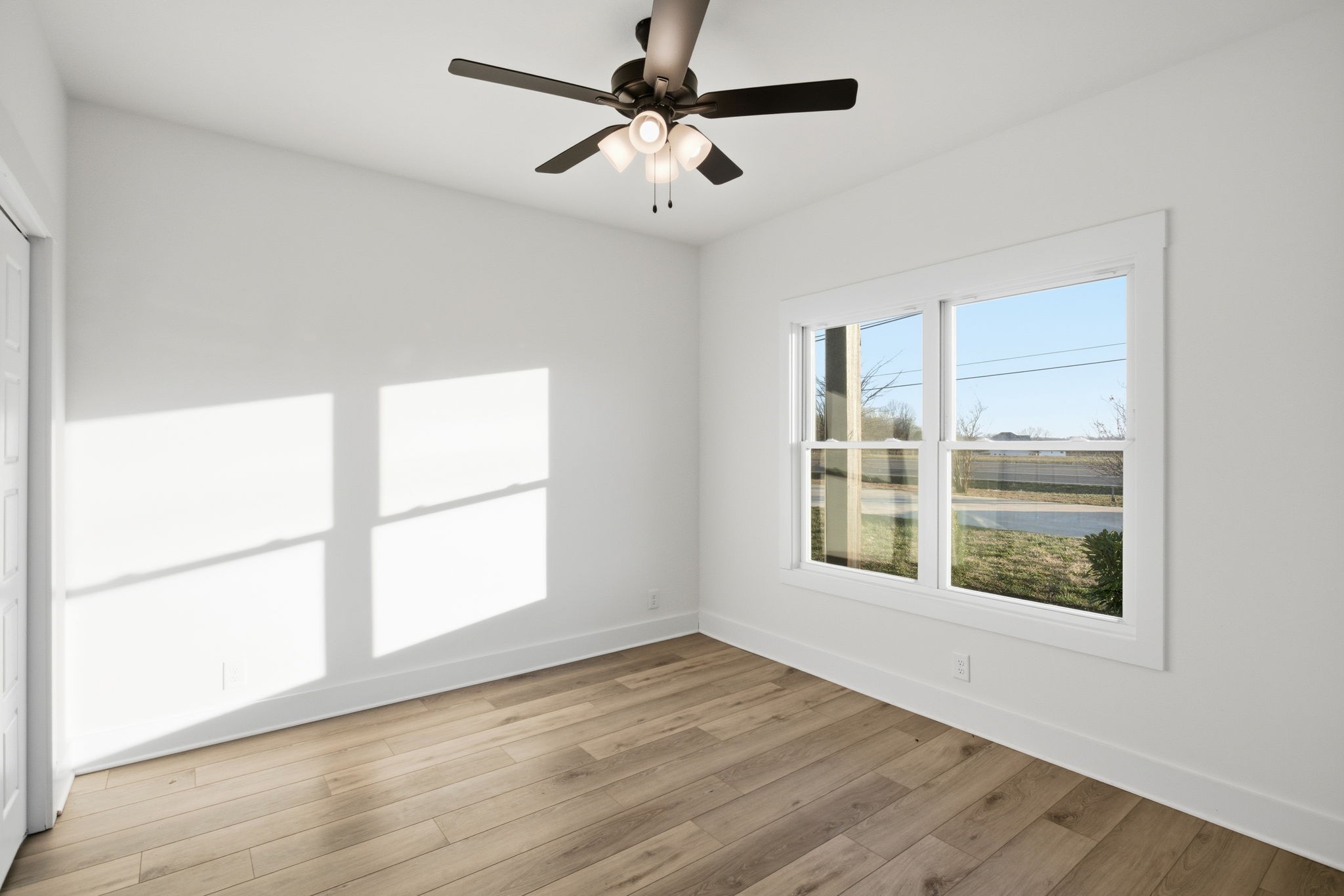 2511 Ashland City Road Clarksville, TN 37043 - Photo 15 of 31 a view of an empty room with a window and wooden floor
