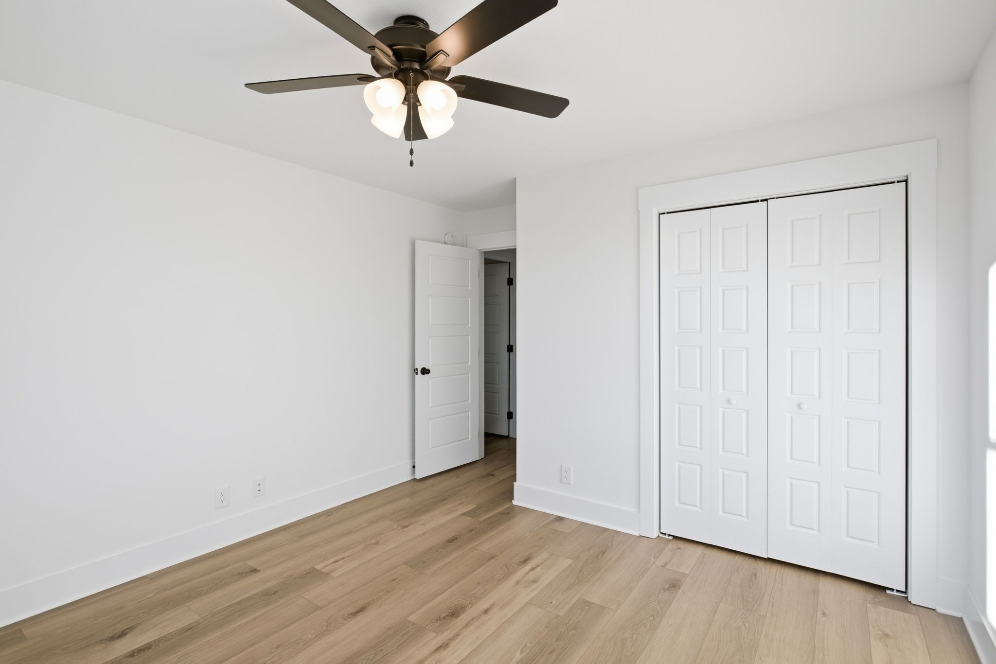 2511 Ashland City Road Clarksville, TN 37043 - Photo 25 of 31 an empty room with wooden floor closet and ceiling fan