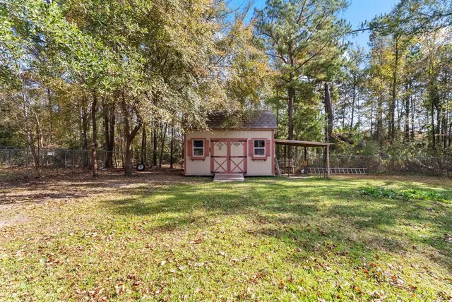 a view of a house with a yard and sitting area