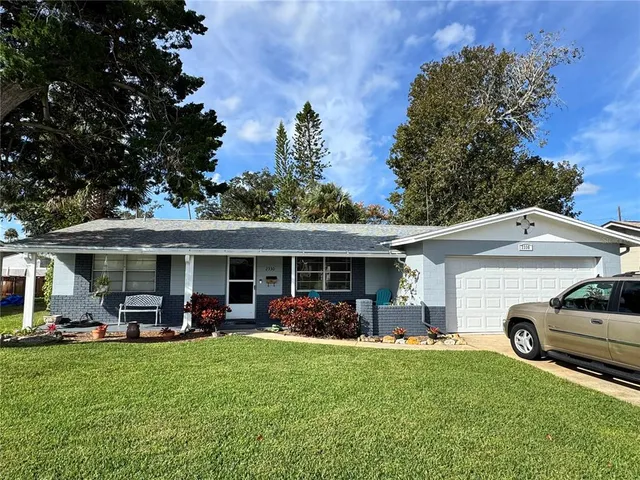 a front view of house with yard outdoor seating and green space