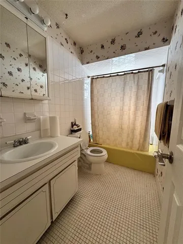 a bathroom with a double vanity sink toilet and shower