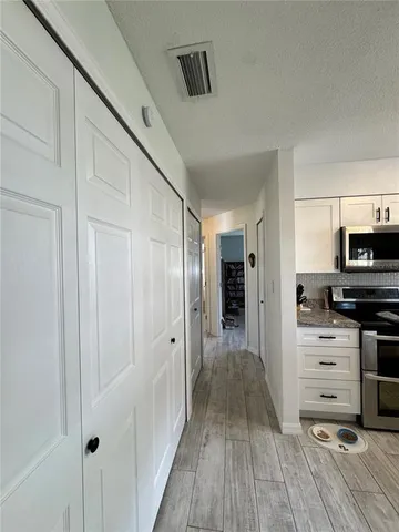 a kitchen with stainless steel appliances a refrigerator and cabinets