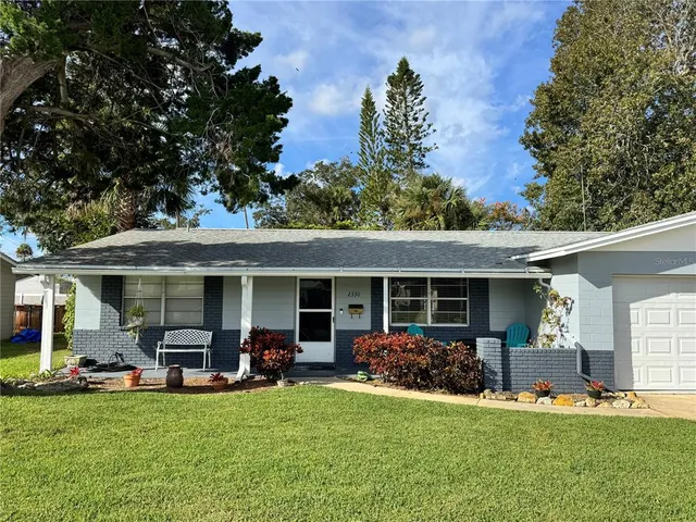 a view of a patio with table and chairs under an umbrella
