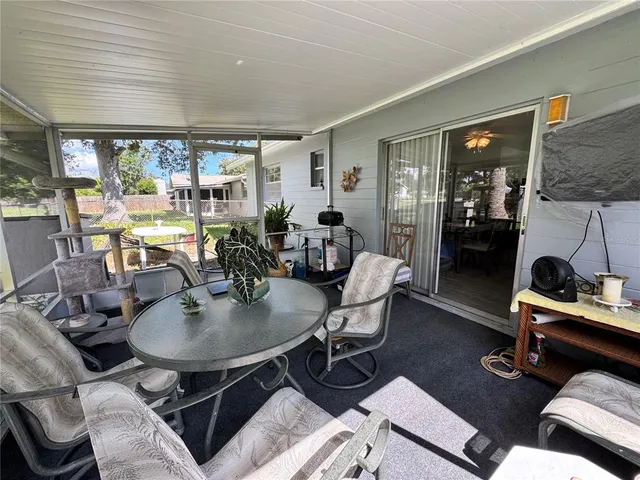 a living room with furniture a flat screen tv and a table
