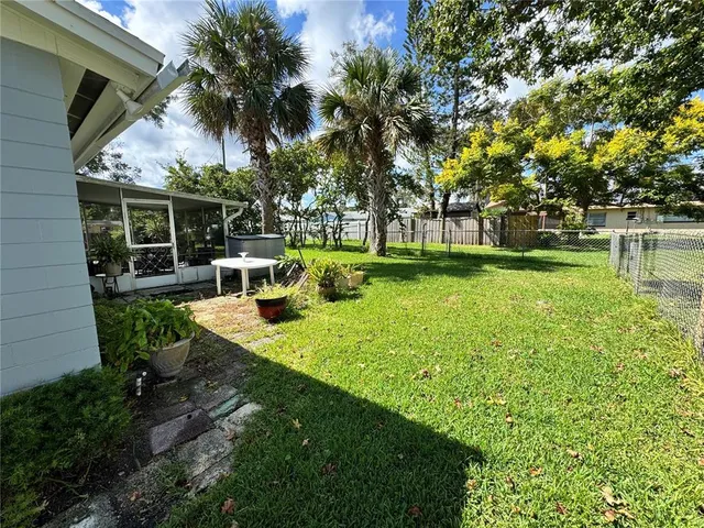 a view of a house with backyard and sitting area