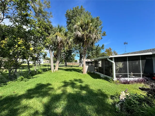 a view of an house with backyard space and garden