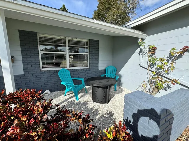 a view of a chairs and table in backyard of the house