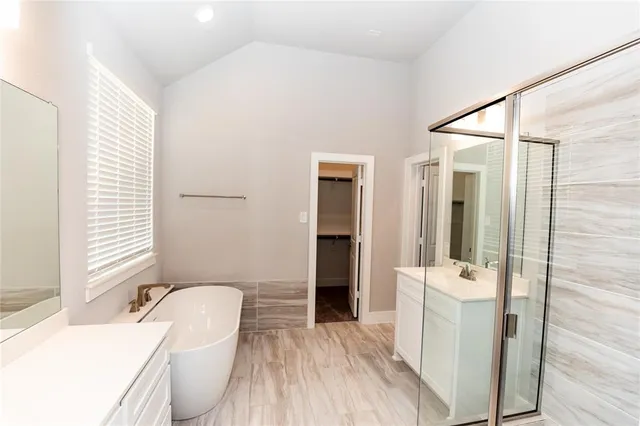 a bathroom with a sink a toilet a tub and shower