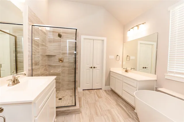 a bathroom with a tub sink and mirror
