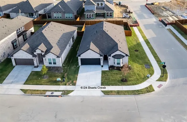 a bed sitting in a bedroom next to a larger window