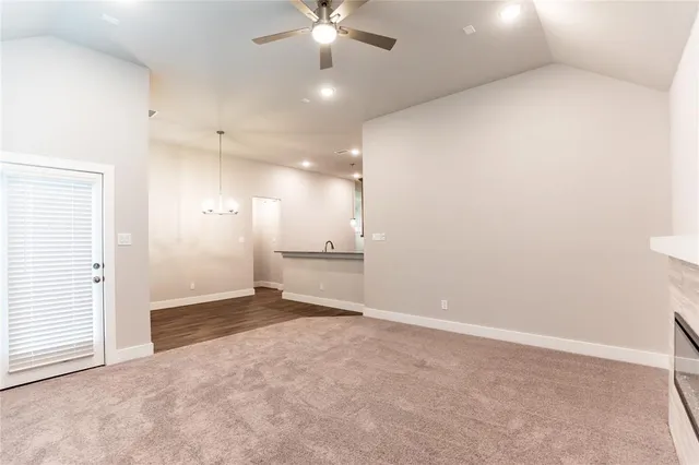 wooden floor in an empty room with a ceiling fan