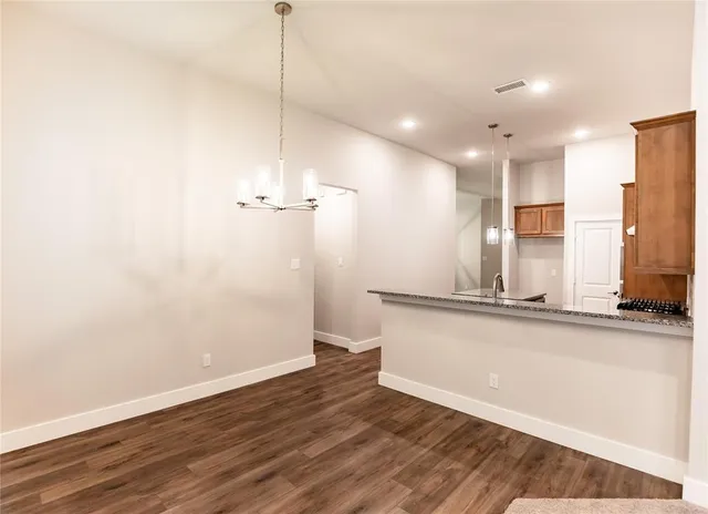 a view of a kitchen with a sink and a refrigerator