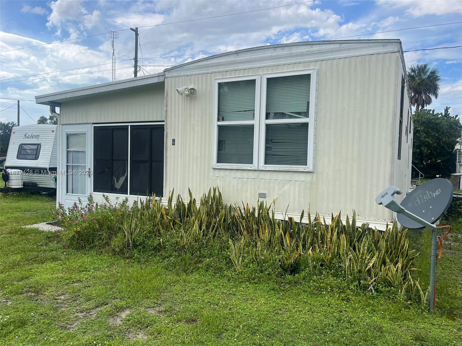 14725 Northwest 1st, Unit RV 4 Okeechobee, FL 34972 - Photo 1 of 11 a view of a house with a yard