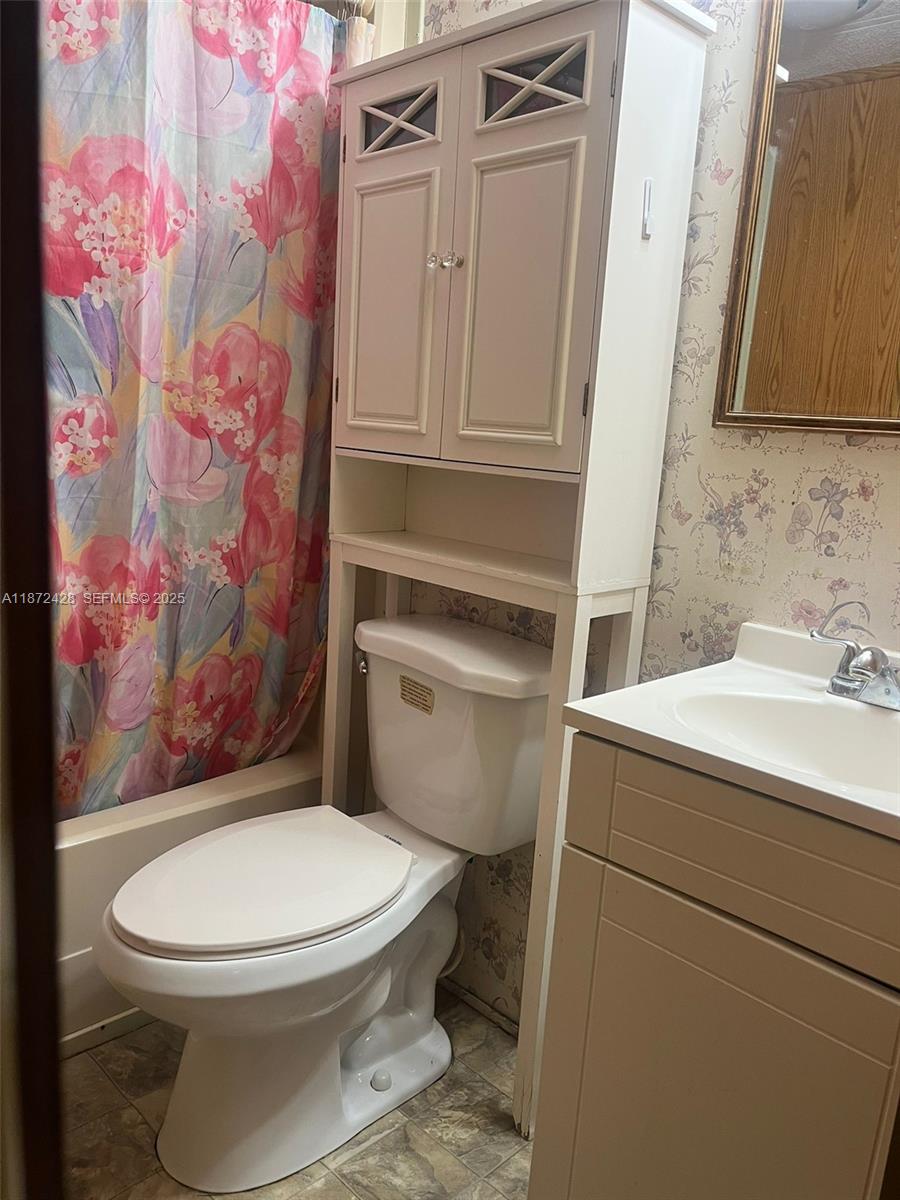14725 Northwest 1st, Unit RV 4 Okeechobee, FL 34972 - Photo 10 of 11 a white toilet sitting next to a bathroom sink
