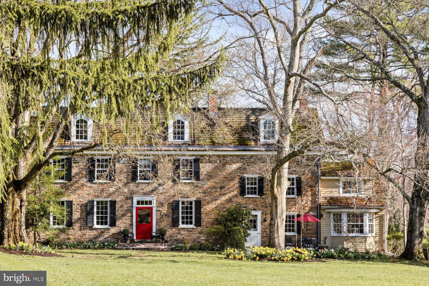 a front view of residential houses with yard and trees