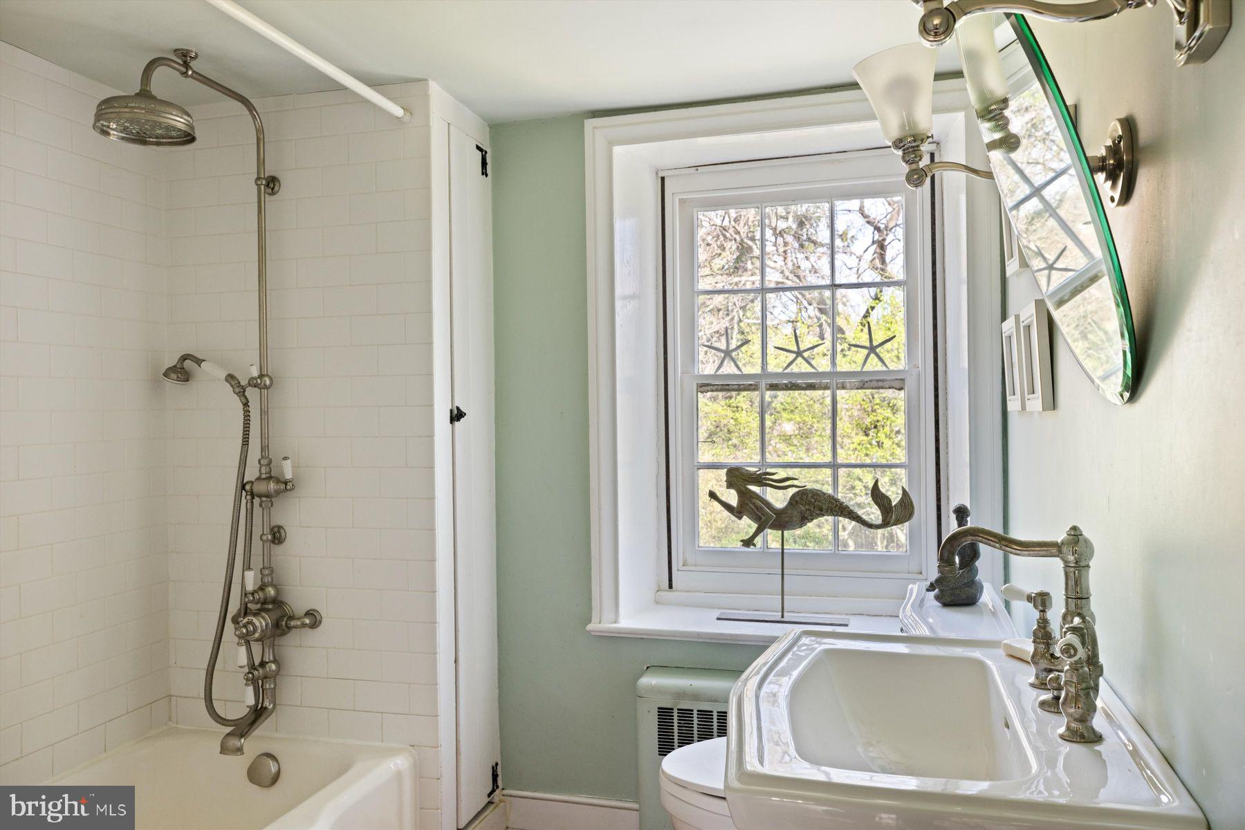 1566 Woodside Road Yardley, PA 19067 - Photo 37 of 50 a bathroom with a sink a window and a shower