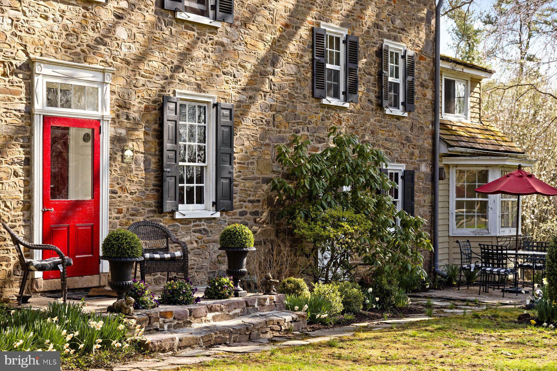 1566 Woodside Road Yardley, PA 19067 - Photo 4 of 50 a view of a building with brick walls and a potted plant