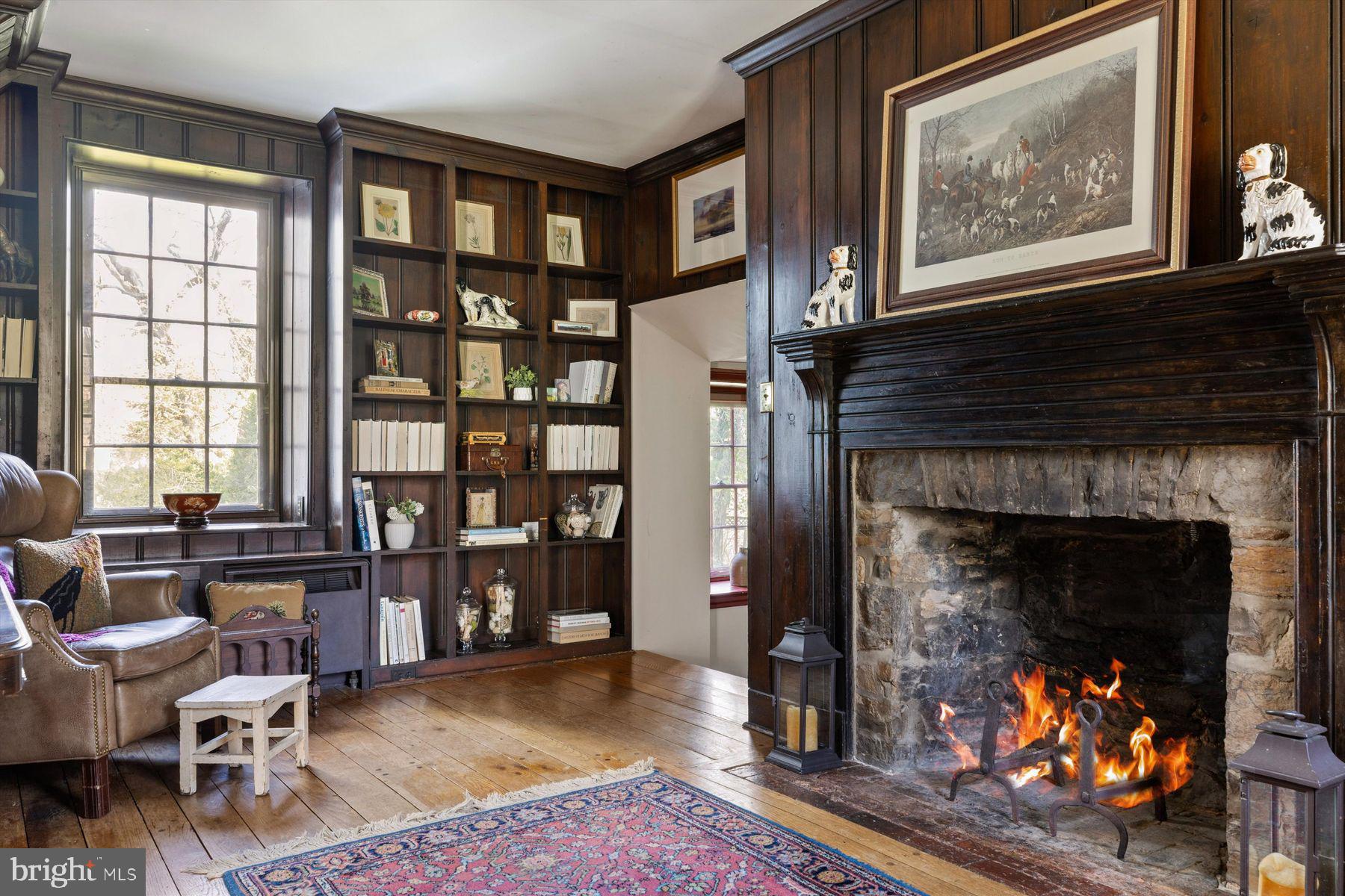 1566 Woodside Road Yardley, PA 19067 - Photo 9 of 50 a living room with furniture a fireplace and a large window