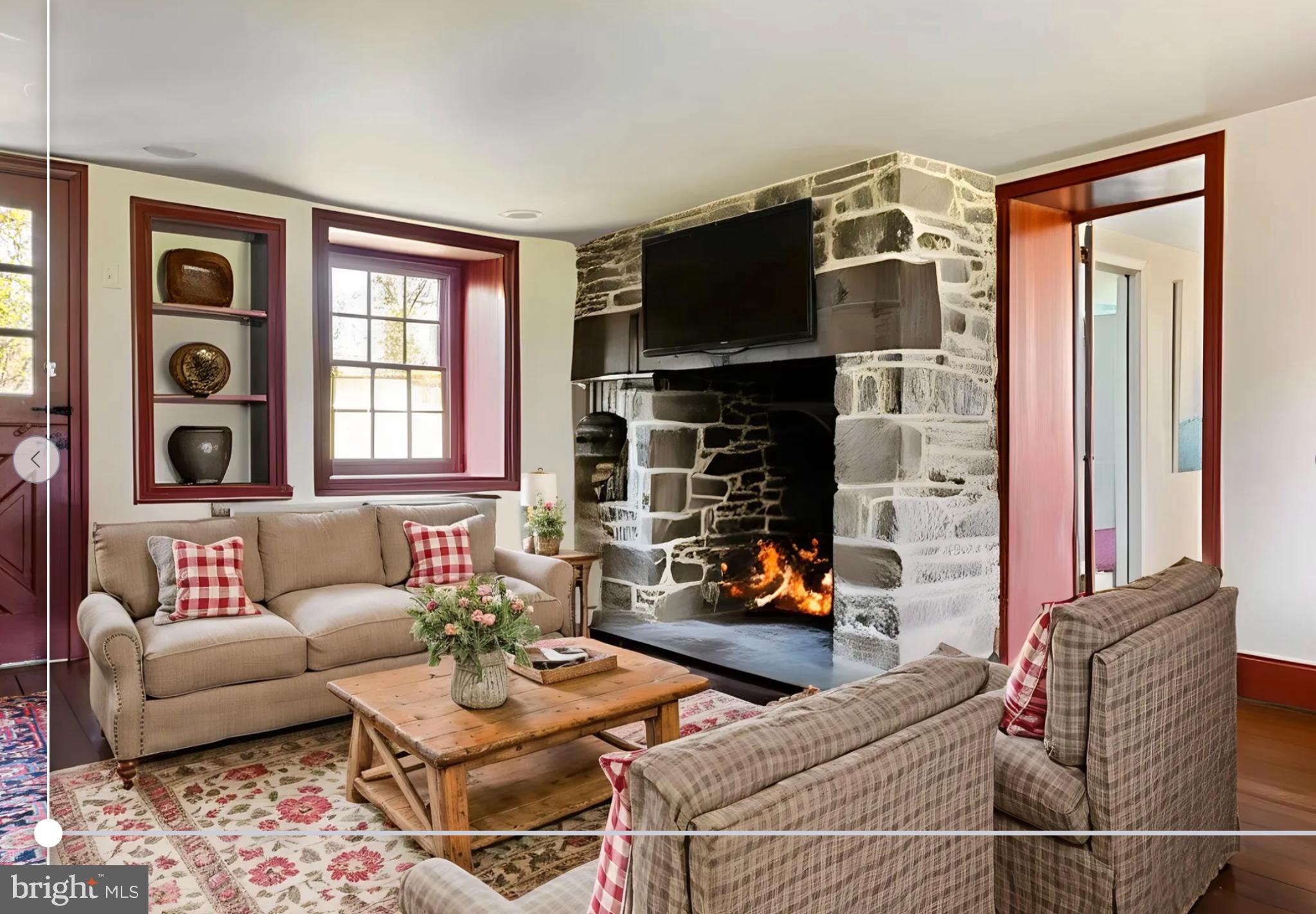 1566 Woodside Road Yardley, PA 19067 - Photo 10 of 50 a living room with furniture a flat screen tv and a fireplace