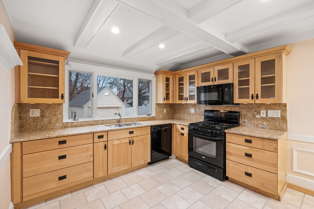 211 Cedar Street Dedham, MA 02026 - Photo 13 of 37 a kitchen with stainless steel appliances granite countertop a stove and cabinets