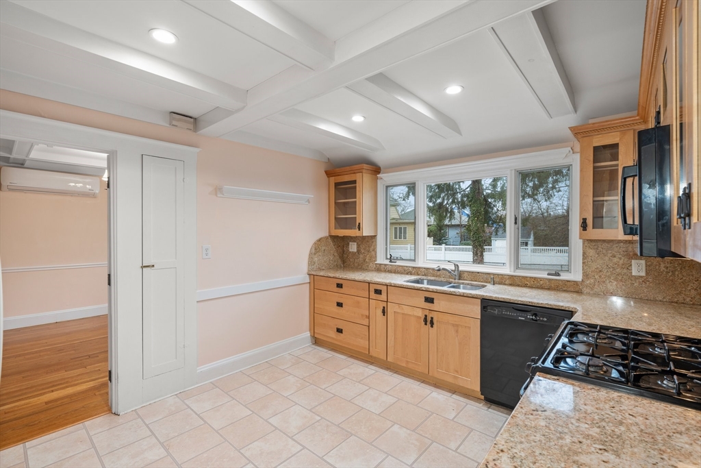 211 Cedar Street Dedham, MA 02026 - Photo 15 of 37 a large kitchen with granite countertop a stove and a sink