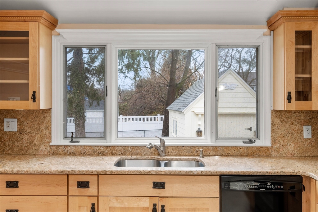 211 Cedar Street Dedham, MA 02026 - Photo 16 of 37 a kitchen with granite countertop a sink and a window