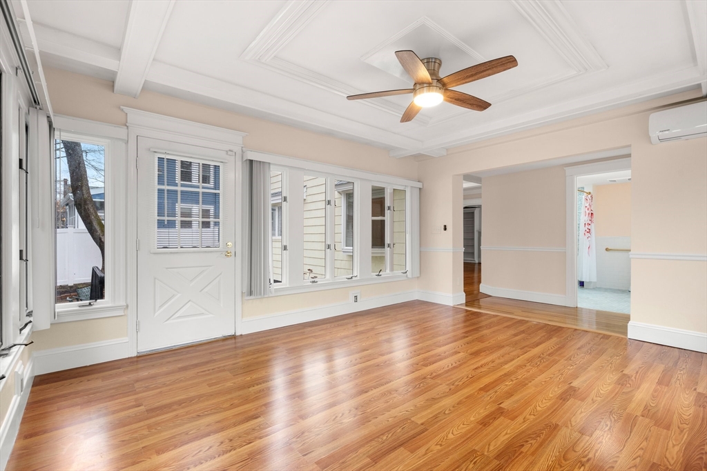 211 Cedar Street Dedham, MA 02026 - Photo 18 of 37 a view of an empty room with wooden floor and a ceiling fan