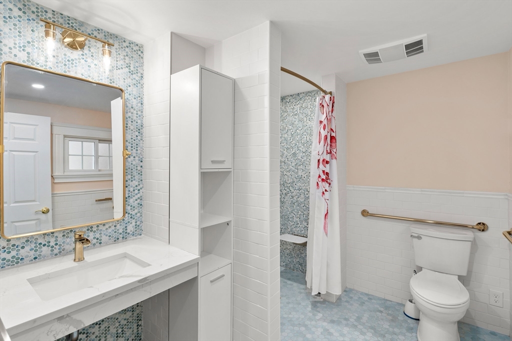 211 Cedar Street Dedham, MA 02026 - Photo 19 of 37 a bathroom with a sink and a mirror