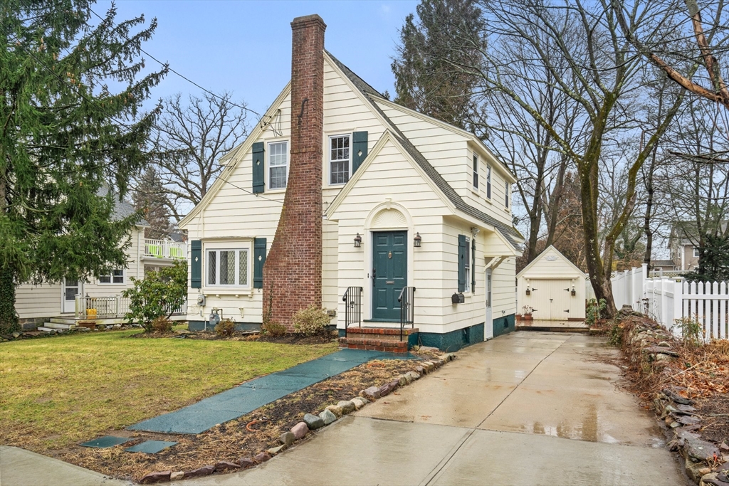 211 Cedar Street Dedham, MA 02026 - Photo 2 of 37 a view of a white house with a yard next to a road