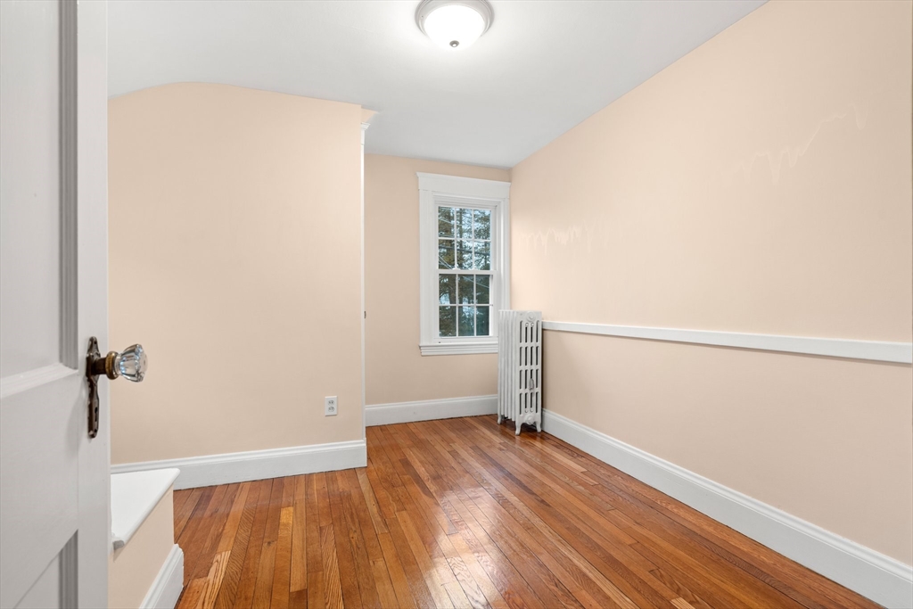 211 Cedar Street Dedham, MA 02026 - Photo 25 of 37 a view of empty room with wooden floor and fan