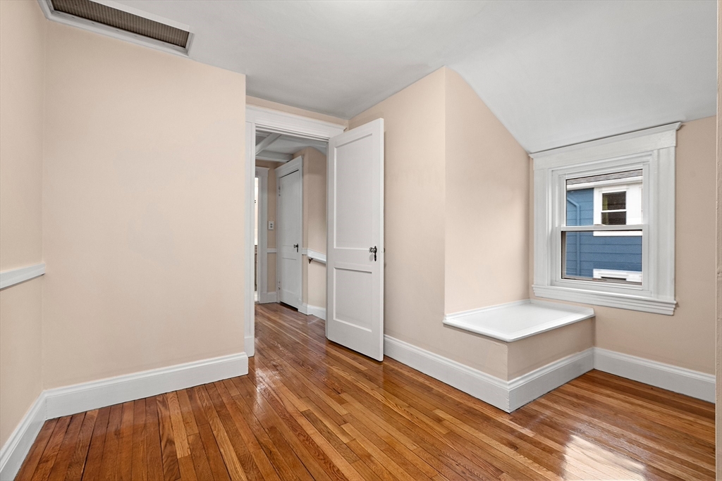 211 Cedar Street Dedham, MA 02026 - Photo 26 of 37 an empty room with wooden floor and windows