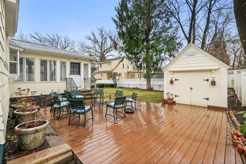 211 Cedar Street Dedham, MA 02026 - Photo 30 of 37 a view of a patio with table and chairs and wooden floor