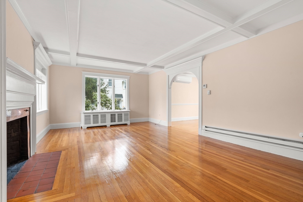 211 Cedar Street Dedham, MA 02026 - Photo 6 of 37 a view of an empty room with wooden floor and a window