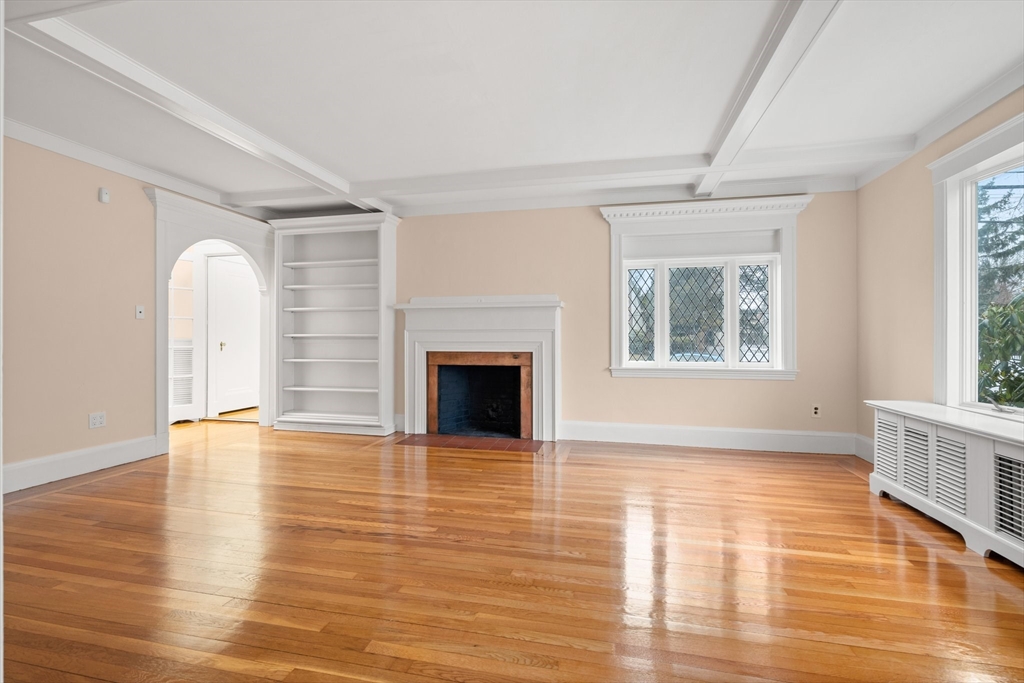211 Cedar Street Dedham, MA 02026 - Photo 7 of 37 a view of an empty room with window and wooden floor
