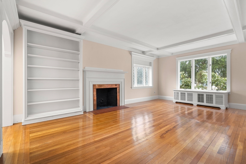 211 Cedar Street Dedham, MA 02026 - Photo 8 of 37 a view of empty room with wooden floor and fireplace