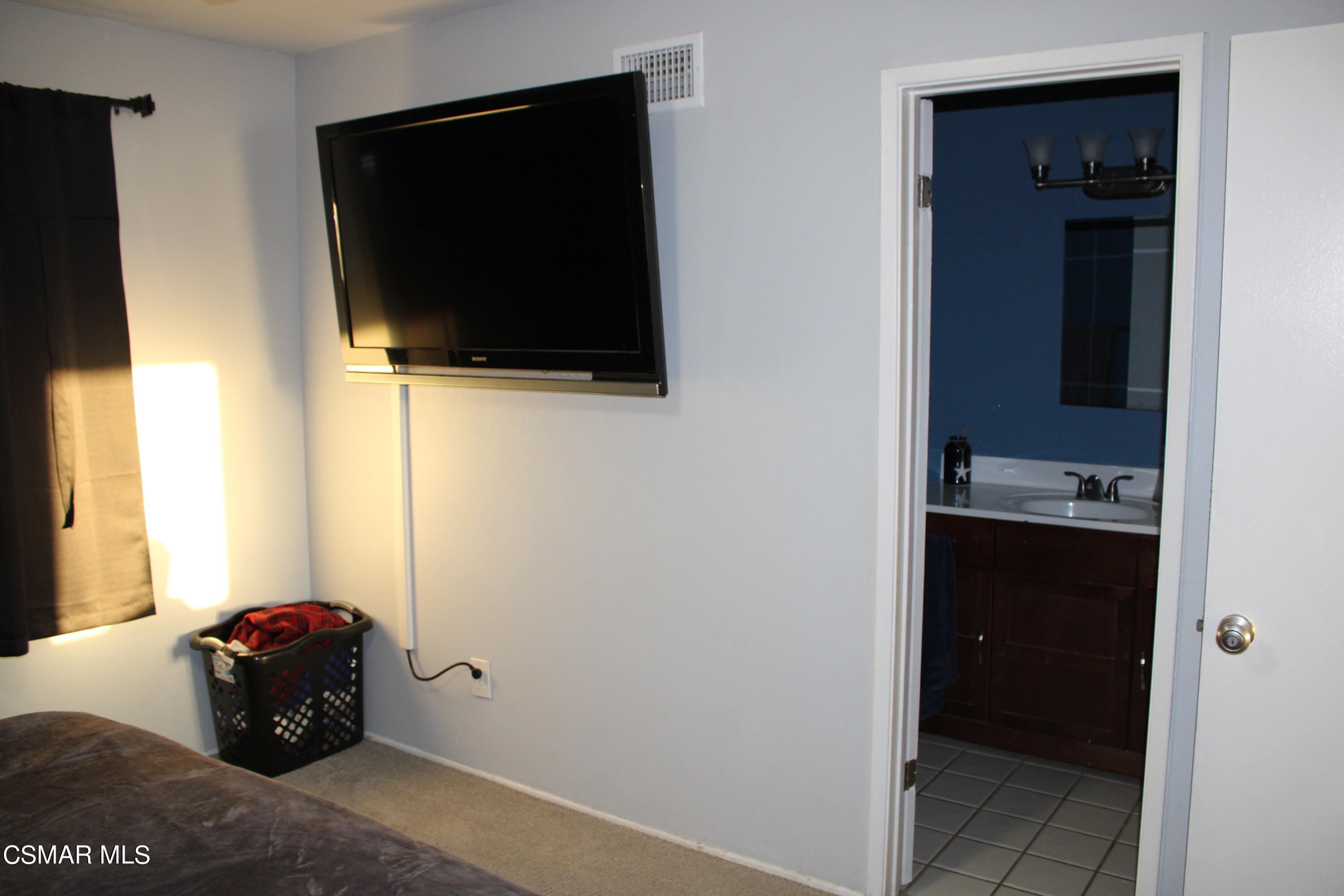 2230 Ralston Street Simi Valley, CA 93063 - Photo 11 of 28 a living room with a flat screen tv and floor to ceiling window