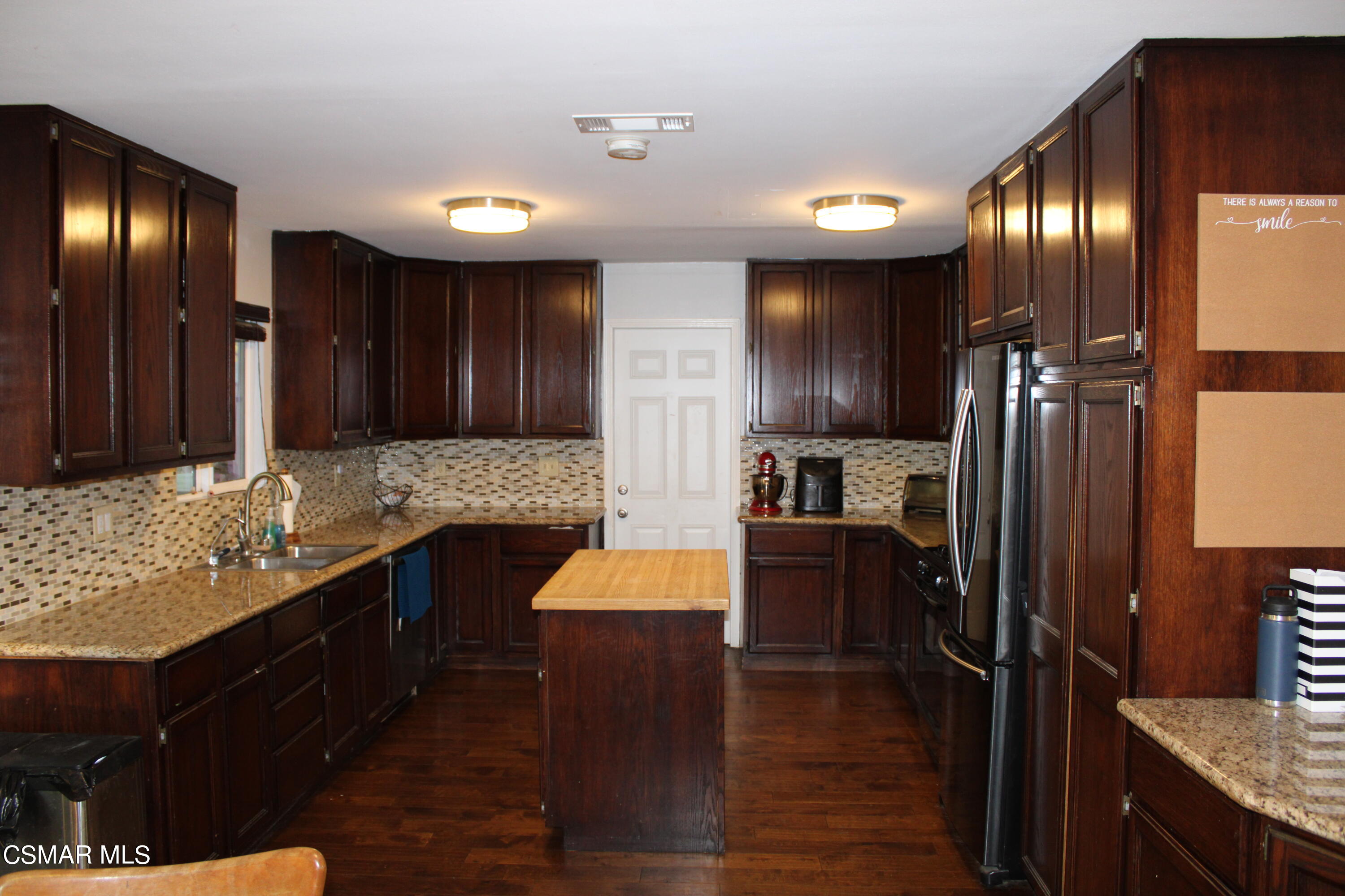 2230 Ralston Street Simi Valley, CA 93063 - Photo 4 of 28 a kitchen with granite countertop stainless steel appliances and wooden cabinets