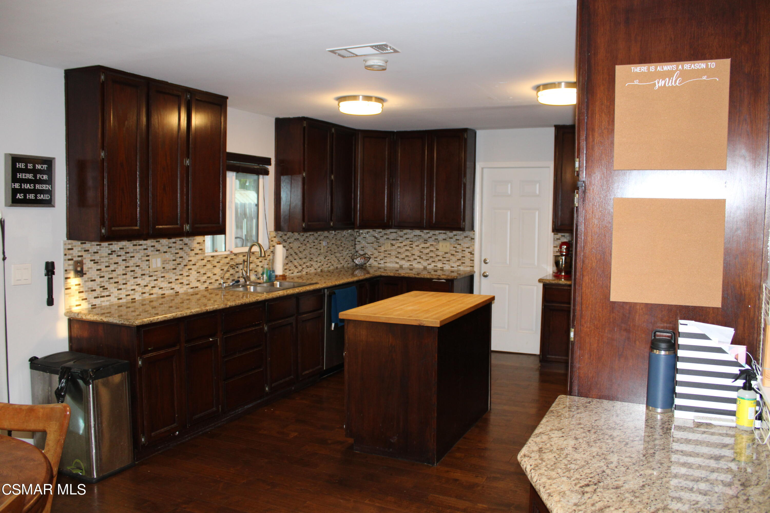 2230 Ralston Street Simi Valley, CA 93063 - Photo 5 of 28 a kitchen with stainless steel appliances granite countertop wooden cabinets and sink
