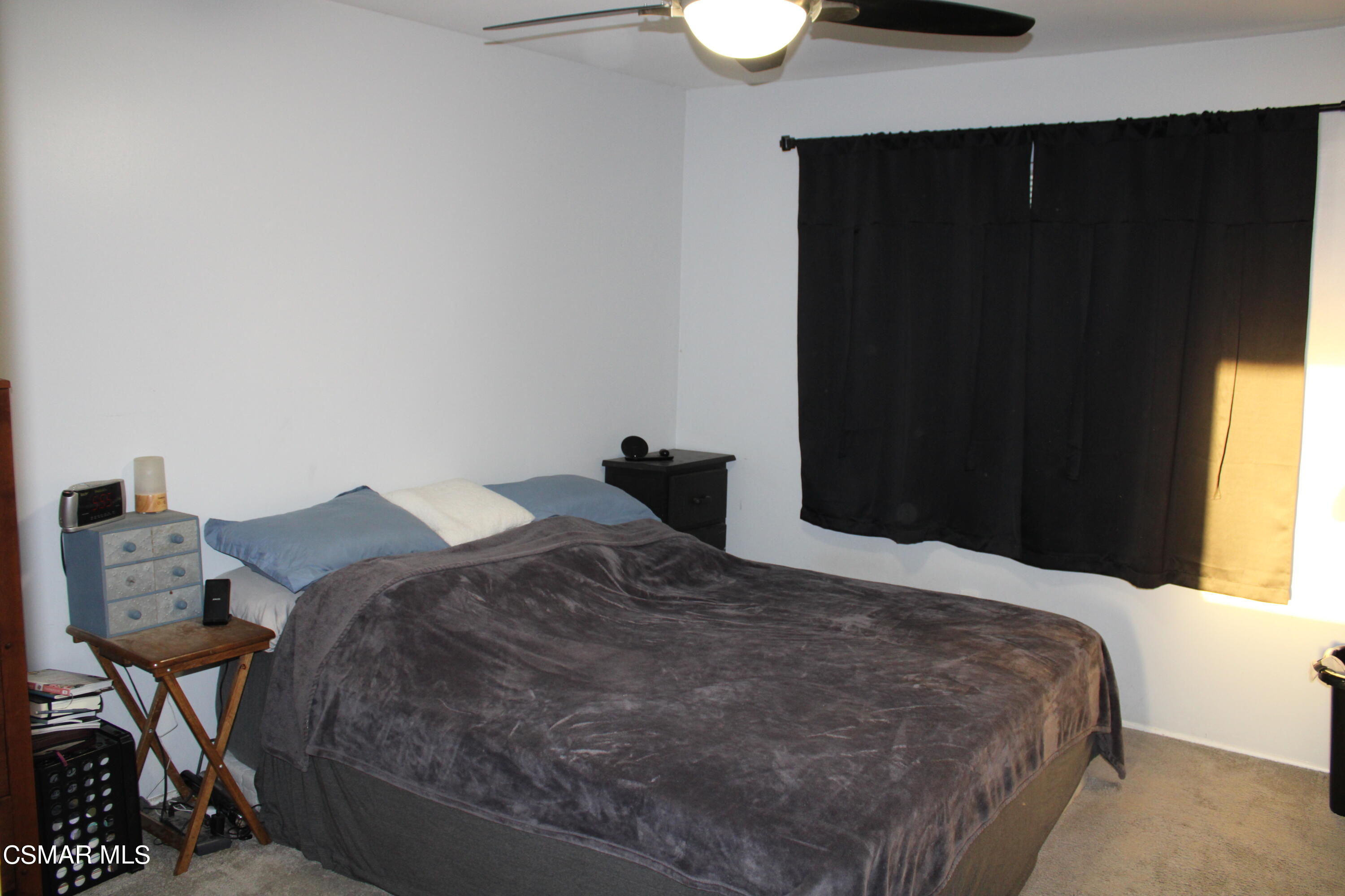 2230 Ralston Street Simi Valley, CA 93063 - Photo 10 of 28 a bedroom with a bed and a lamp on table